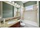 Bathroom features granite countertop vanity, tiled shower/tub combo, and large mirror at 15908 Cobble Mill Dr, Wimauma, FL 33598