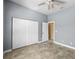 Bedroom with tile flooring, ceiling fan, sliding door closet, and entry to an adjacent room at 15908 Cobble Mill Dr, Wimauma, FL 33598