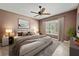 Comfortable bedroom with neutral-toned walls, a ceiling fan, and lots of natural light from the windows at 15908 Cobble Mill Dr, Wimauma, FL 33598