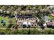 Aerial view of community garden featuring raised garden beds and charming sheds in lush landscaping at 15908 Cobble Mill Dr, Wimauma, FL 33598