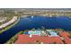 Expansive community pool area features multiple pools, palm trees, and lake views for a resort-style experience at 15908 Cobble Mill Dr, Wimauma, FL 33598