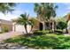 Attractive house showcasing a 2-car garage, well-manicured lawn and lovely palm trees at 15908 Cobble Mill Dr, Wimauma, FL 33598