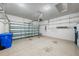 This is a spacious garage with speckled epoxy flooring and an automatic garage door opener at 15908 Cobble Mill Dr, Wimauma, FL 33598