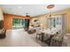 Bright and airy living room featuring a dining table and sliding glass doors to outdoor space at 15908 Cobble Mill Dr, Wimauma, FL 33598