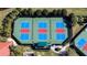 Aerial view of colorful pickleball court with well-maintained surfaces, seating, and green surroundings at 15908 Cobble Mill Dr, Wimauma, FL 33598