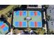 Aerial view of a pickleball court featuring vibrant blue and red play areas at 15908 Cobble Mill Dr, Wimauma, FL 33598