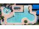 Aerial view of a spacious community pool with lounge chairs and well-maintained landscaping, perfect for relaxation at 15908 Cobble Mill Dr, Wimauma, FL 33598