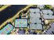 Aerial view showcases well-maintained tennis courts, pickleball courts, and verdant landscaping at 15908 Cobble Mill Dr, Wimauma, FL 33598