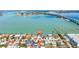 Aerial shot of a waterfront property featuring a bridge, sunny skies, and gorgeous water views at 173 1St W St, Tierra Verde, FL 33715