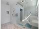 Bright bathroom featuring a glass shower, stone pebble flooring, and stylish fixtures, adding modern elegance at 173 1St W St, Tierra Verde, FL 33715