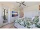 Bedroom features a ceiling fan, balcony access, and a mounted television at 173 1St W St, Tierra Verde, FL 33715