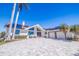 This is a beautiful front exterior with a circular driveway and seating at the front door at 173 1St W St, Tierra Verde, FL 33715