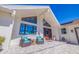 This home's front porch boasts comfortable outdoor seating and a view of the manicured front yard at 173 1St W St, Tierra Verde, FL 33715