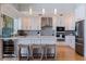 Gourmet kitchen features white cabinets, modern appliances, and a stylish breakfast bar at 173 1St W St, Tierra Verde, FL 33715