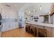Modern kitchen with stainless steel appliances, white cabinets, and an island with seating at 173 1St W St, Tierra Verde, FL 33715