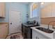 Laundry room with modern washer and dryer, sink and storage at 173 1St W St, Tierra Verde, FL 33715