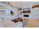 Comfortable living room featuring a fireplace, built-in shelving, and light hardwood floors at 173 1St W St, Tierra Verde, FL 33715