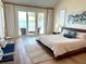 Serene main bedroom with water views, stylish decor, and access to a private balcony at 173 1St W St, Tierra Verde, FL 33715
