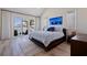 Bright main bedroom featuring slider to the water, vaulted ceiling, and wood floors at 173 1St W St, Tierra Verde, FL 33715