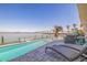 Relaxing poolside patio with comfortable seating and captivating waterfront views and serene bridge vista at 173 1St W St, Tierra Verde, FL 33715