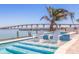 A refreshing wading pool has built-in seating for relaxation and soaking up the sun at 173 1St W St, Tierra Verde, FL 33715
