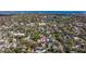 Extensive aerial view of a dense residential area with a glimpse of a blue lake in the distance at 1820 11Th N St, St Petersburg, FL 33704