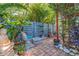 Charming backyard patio with a fence, mature landscaping, and a Buddha statue at 1820 11Th N St, St Petersburg, FL 33704