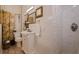 Bathroom featuring a vanity sink, tiled walk-in shower, and colorful curtains, providing a functional and stylish space at 1820 11Th N St, St Petersburg, FL 33704