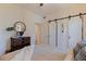 Bright bedroom featuring a rustic dresser, white trim, and sliding doors at 1820 11Th N St, St Petersburg, FL 33704