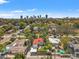 Aerial view showcasing a charming neighborhood with lush greenery and a distant city skyline at 209 17Th N Ave, St Petersburg, FL 33704