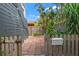 Enclosed backyard featuring brick-paved area, wooden fence, tropical plants, and a private setting at 209 17Th N Ave, St Petersburg, FL 33704
