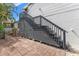 Outdoor staircase of a house featuring a gray staircase with brick patio and tropical vegetation at 209 17Th N Ave, St Petersburg, FL 33704
