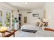 Bright bedroom boasts a bed, mini-fridge, and French doors leading outside at 209 17Th N Ave, St Petersburg, FL 33704
