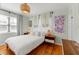 Comfortable bedroom with a queen bed, decorative lighting, and stylish window coverings at 209 17Th N Ave, St Petersburg, FL 33704