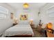 Inviting bedroom with a patterned bedspread, decorative lighting, and a relaxing atmosphere at 209 17Th N Ave, St Petersburg, FL 33704