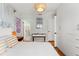 Bright bedroom featuring white furnishings, wood floors, and updated lighting at 209 17Th N Ave, St Petersburg, FL 33704