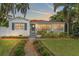 Well-maintained home featuring a lush front lawn, neatly trimmed hedges, and a welcoming entrance at 209 17Th N Ave, St Petersburg, FL 33704
