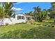 Beautiful home featuring a lush green lawn, tasteful landscaping, and charming architectural details at 209 17Th N Ave, St Petersburg, FL 33704