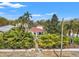 Beautiful front exterior featuring a charming garden, lush trees and a well-manicured lawn at 209 17Th N Ave, St Petersburg, FL 33704