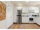 Bright kitchen featuring white cabinetry, stainless steel refrigerator, and hardwood floors at 209 17Th N Ave, St Petersburg, FL 33704