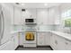 A well-lit kitchen features white cabinets, sleek countertops, and modern appliances at 209 17Th N Ave, St Petersburg, FL 33704