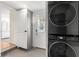 Laundry area with stacked appliances next to white door and cabinets at 209 17Th N Ave, St Petersburg, FL 33704