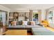 Inviting living room with hardwood floors, comfortable seating, and a stylish shelving unit at 209 17Th N Ave, St Petersburg, FL 33704