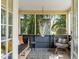 Cozy sunroom with a hammock, wicker chair, and views of the tropical backyard at 209 17Th N Ave, St Petersburg, FL 33704