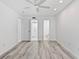 Bright bedroom with wood-style flooring and dual doors to closets and bathroom at 209 Ne Lincoln N Cir # 105, St Petersburg, FL 33702