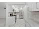 Updated kitchen featuring modern stainless steel appliances and tiled floor at 209 Ne Lincoln N Cir # 105, St Petersburg, FL 33702