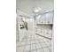 Recently upgraded kitchen boasts white cabinets, sleek appliances, and modern tile floors at 209 Ne Lincoln N Cir # 105, St Petersburg, FL 33702