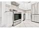 Modern kitchen with stainless steel appliances, white cabinetry, and stylish tile flooring at 209 Ne Lincoln N Cir # 105, St Petersburg, FL 33702