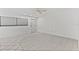 A bright living room featuring tile flooring, a ceiling fan, and a neutral color palette at 209 Ne Lincoln N Cir # 105, St Petersburg, FL 33702