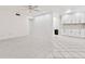 Spacious living room with tiled floors and view to the kitchen at 209 Ne Lincoln N Cir # 105, St Petersburg, FL 33702